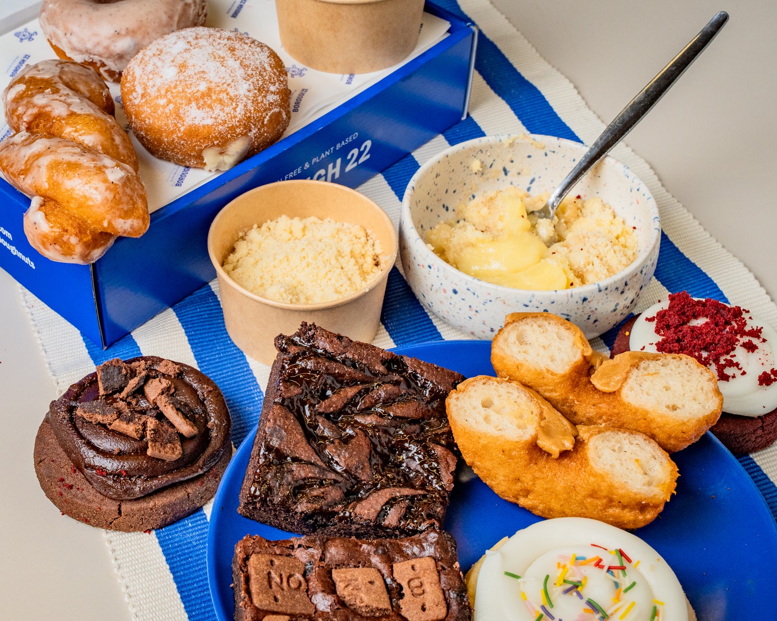 A styled assortment of gluten free and vegan baked goods and desserts.