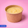 Gluten free vegan vanilla custard pot in a kraft tub, flecked with vanilla seeds