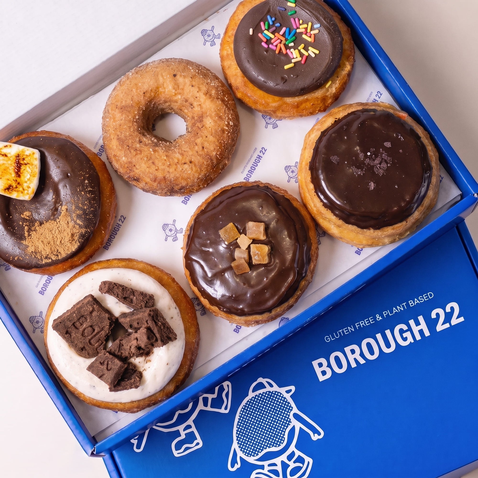 Open Borough 22 box of six gluten free vegan baked chocolate doughnuts, s'mores with toasted marshmallow, salted caramel, jaffa, cookies and cream, and cinnamon sugar
