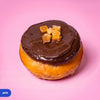 Gluten free vegan baked jaffa doughnut, dark chocolate icing topped with candied orange pieces