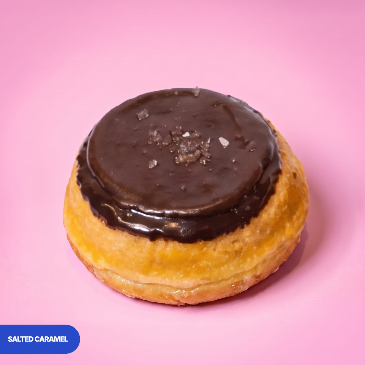 Gluten free vegan baked salted caramel doughnut, chocolate icing finished with sea salt flakes