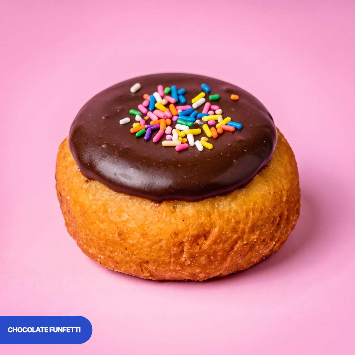 Gluten free vegan baked chocolate funfetti doughnut, chocolate icing covered in rainbow sprinkles