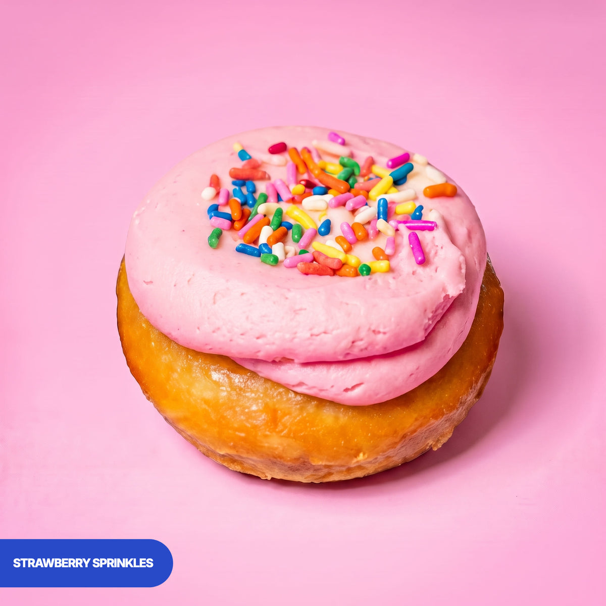 Gluten free vegan baked strawberry doughnut, pink strawberry icing covered in rainbow sprinkles
