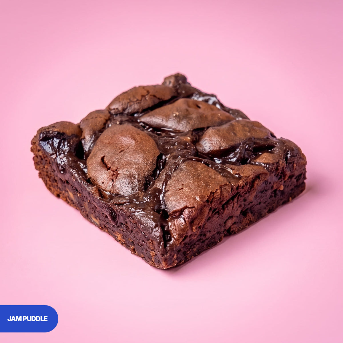 Gluten free vegan jam puddle brownie with glossy dark jam pools and a fudgy chocolate centre
