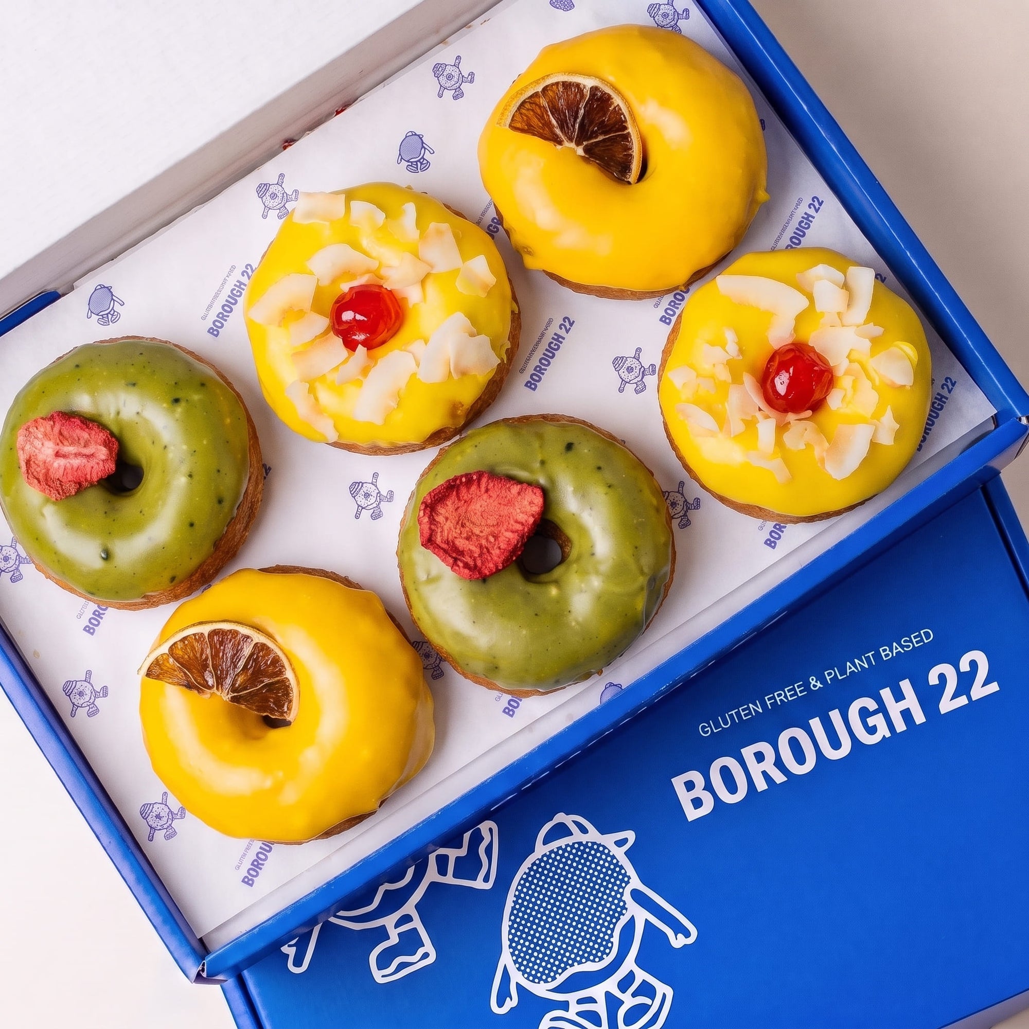 Open Borough 22 box of six gluten free vegan fried doughnuts, two matcha with freeze dried strawberry, two mango lime and two pina colada with coconut and cherry