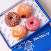 Gluten free vegan Little Celebration Box with a hundreds and thousands Dot, jam filled, custard filled and pink strawberry sprinkles doughnut