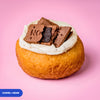 Gluten free vegan fried cookies and cream doughnut, vanilla cream topped with chocolate biscuit pieces
