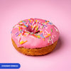 Gluten free vegan fried strawberry ring doughnut, pink icing covered in rainbow sprinkles