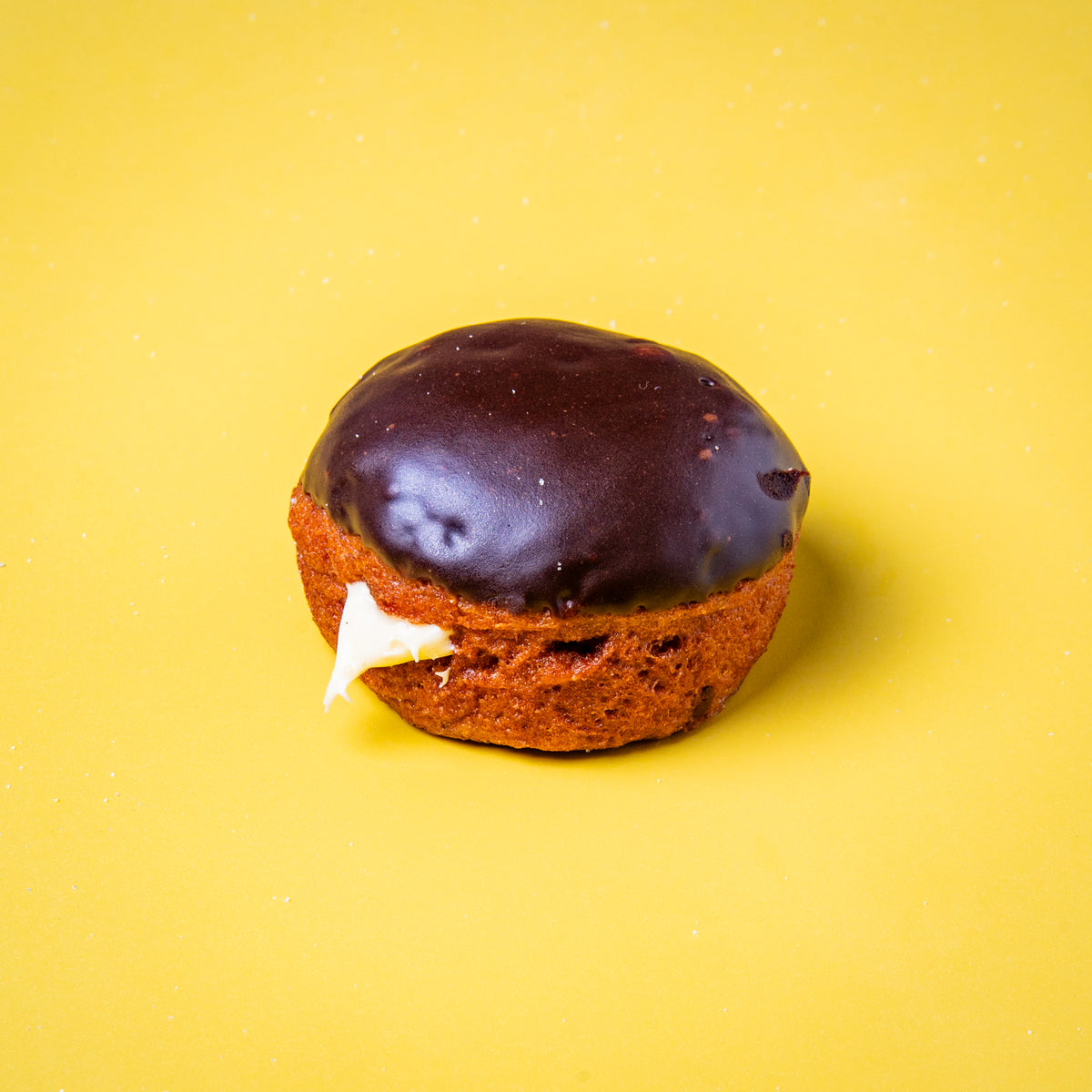 Gluten free vegan Boston Cream doughnut with chocolate glaze and custard filling, from the Taster Box
