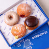 Gluten free vegan taster box of 4 doughnuts: OG vanilla bean ring, jam filled, custard filled and Boston Cream in a Borough 22 box