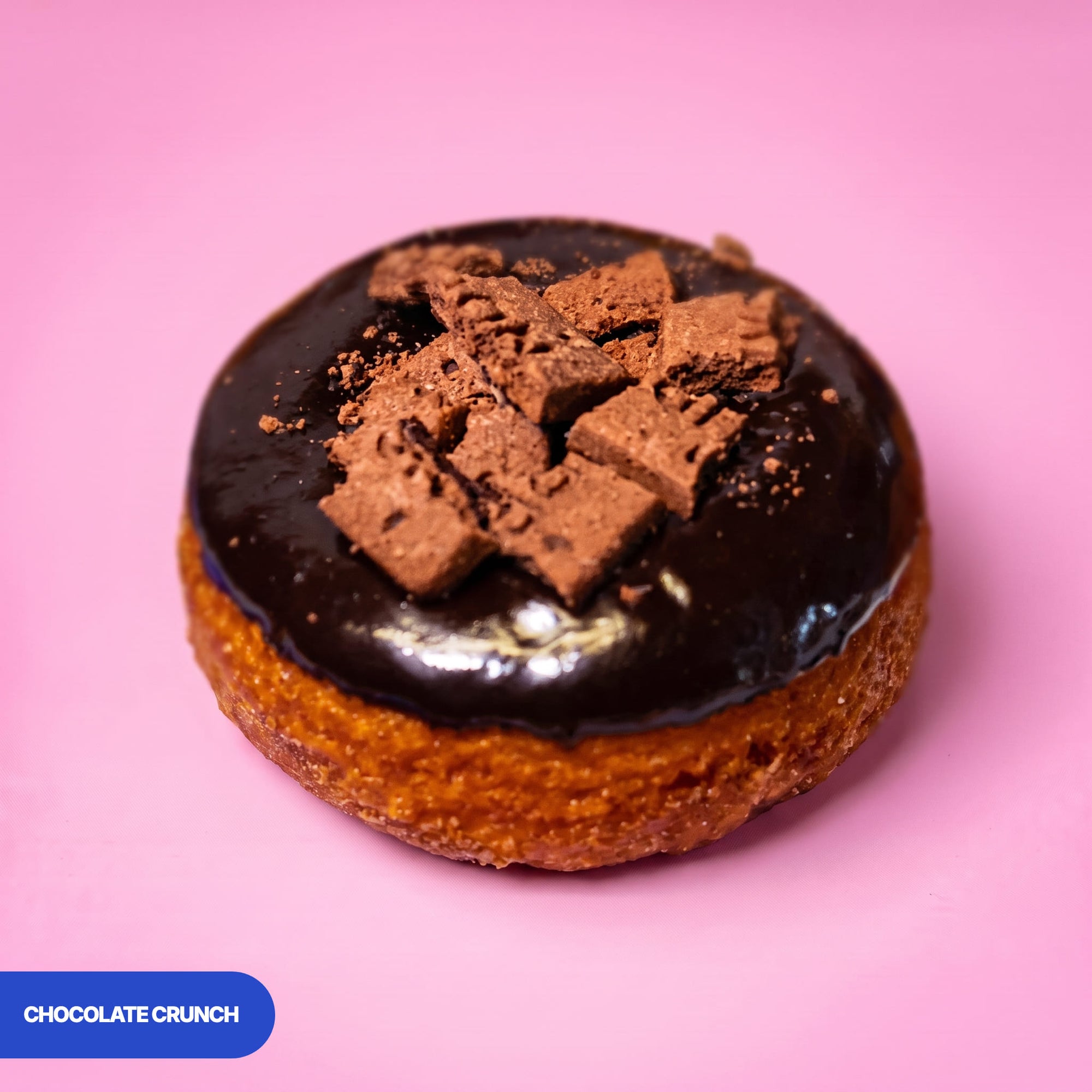 Gluten free oat free vegan fried chocolate crunch doughnut, dark chocolate icing topped with chocolate biscuit pieces