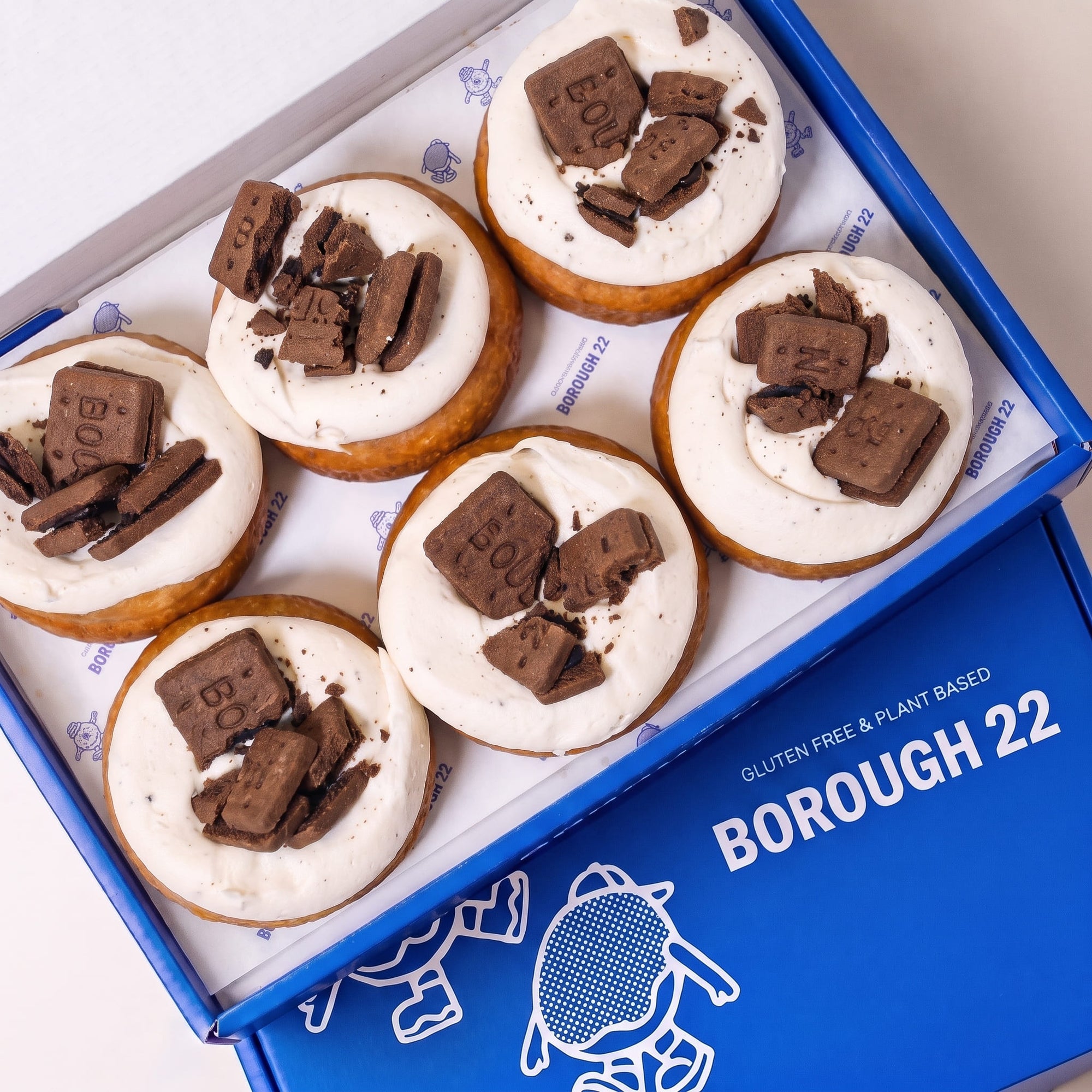 Open Borough 22 box of six gluten free oat free vegan fried cookies and cream doughnuts, topped with vanilla cream and chocolate biscuit pieces